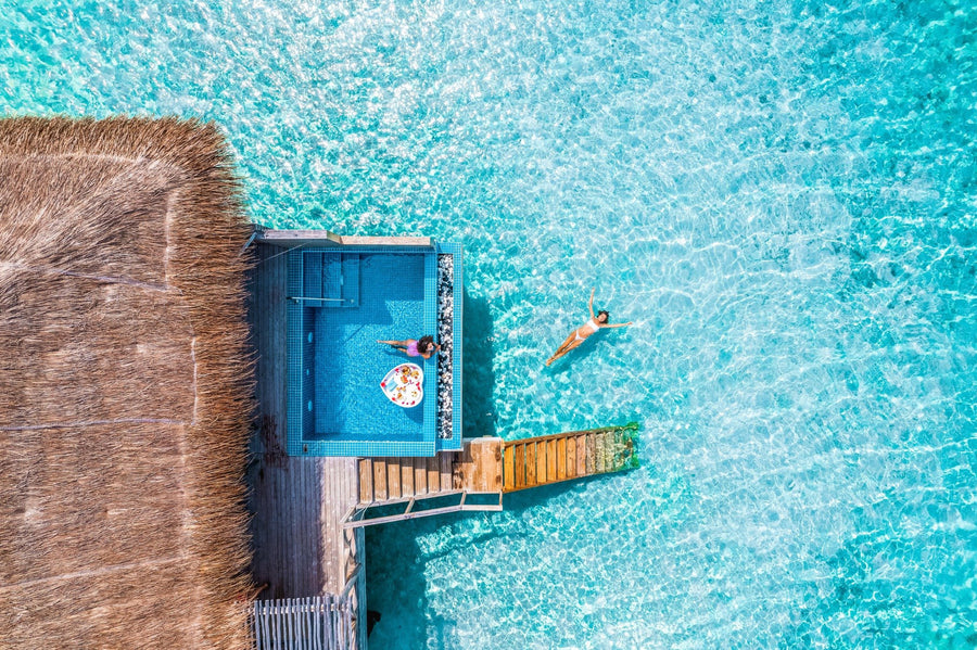 The deck and pool of an overwater villa at You & Me Maldives.
