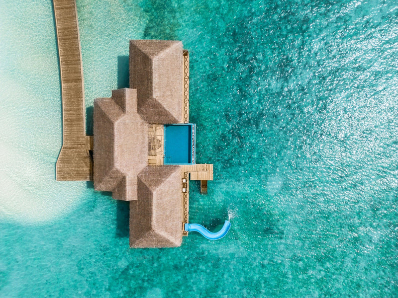 A villa with a pool at You & Me Maldives from the air.
