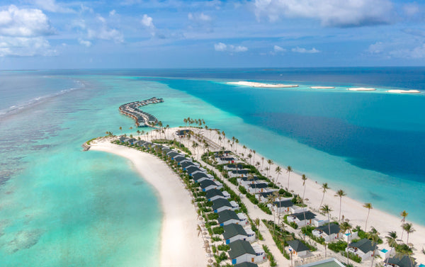 Joy Island from the air, the overwater villas running out from the beach.
