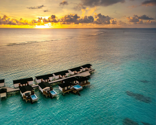 The overwater villas at Joy Island at sunset.