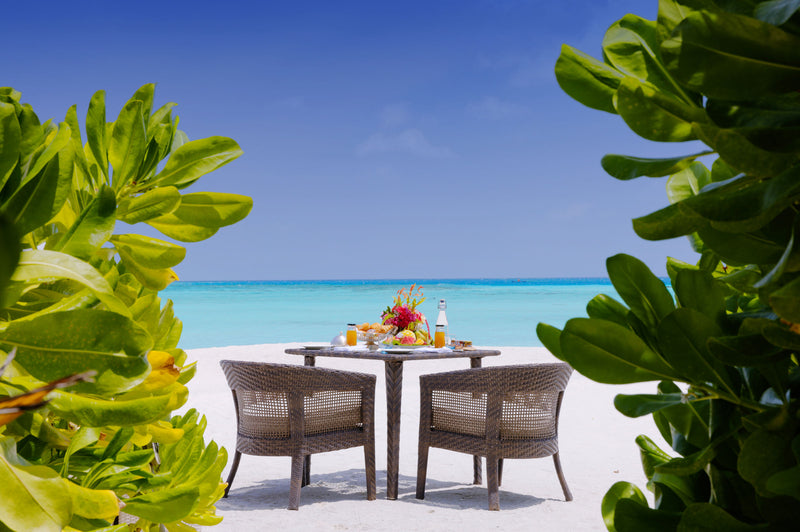 A table set by the sea at You & Me Maldives.