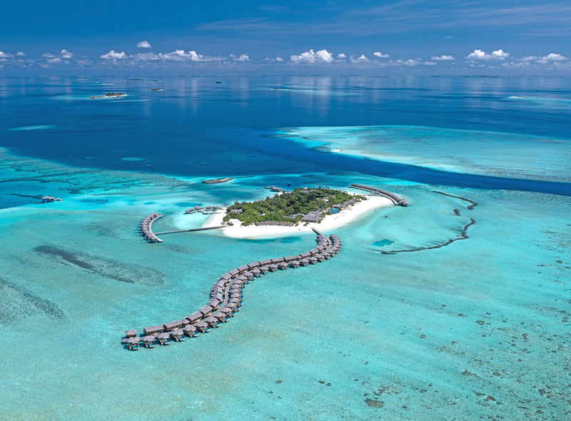 The overwater villas at You & Me Maldives from the air.