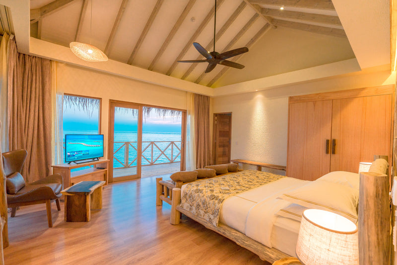 A bedroom opening to the sea at You & Me Maldives.
