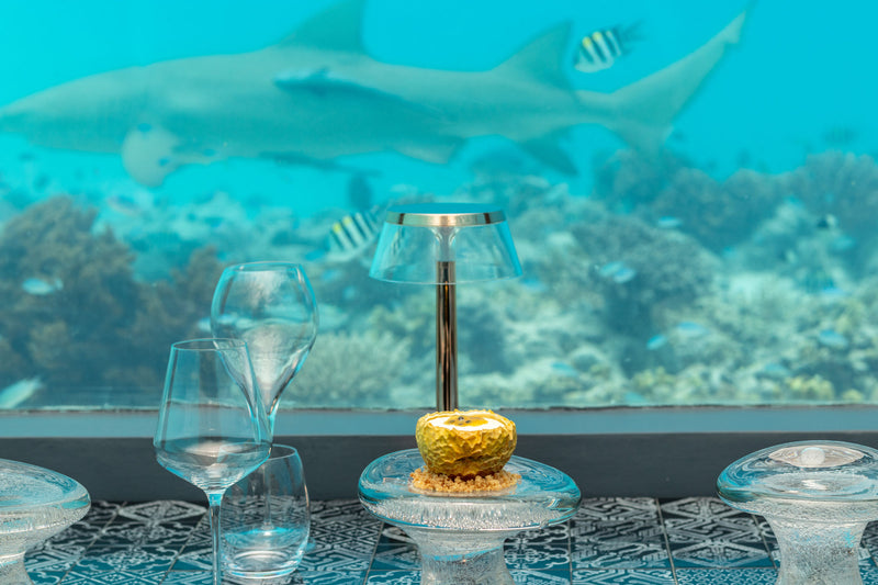 A table set inside the underwater restaurant at You & Me Maldives.