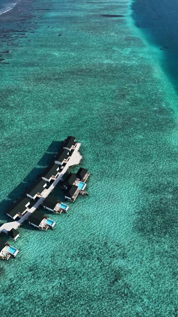 An overwater villa with a pool at Joy Island from the air.