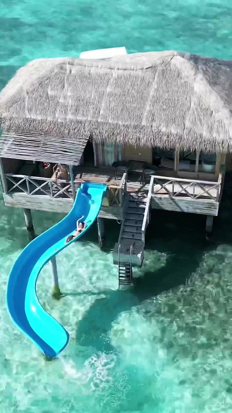 A water slide from an overwater villa at You & Me Maldives.