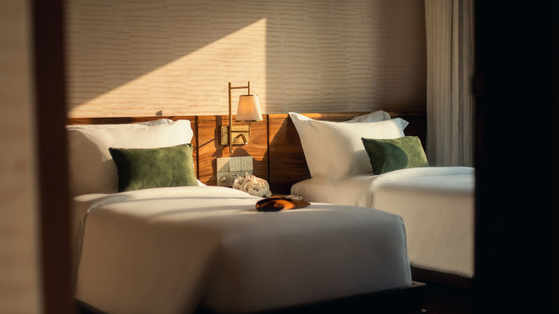 A twin bedroom at RAH GILI Maldives.