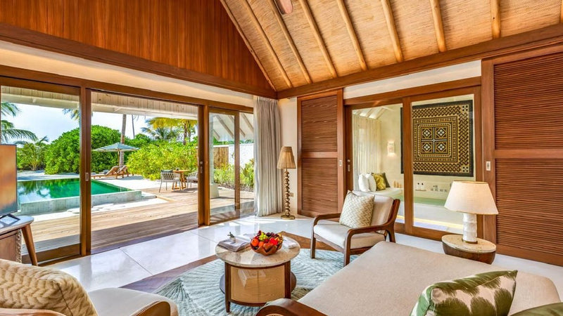 A villa living area opening to the pool at RAH GILI Maldives.