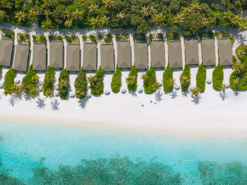 Jawakara Islands Maldives, Lhaviyani Atoll: a row of Dheru beach villas behind the white sand, seen from directly above