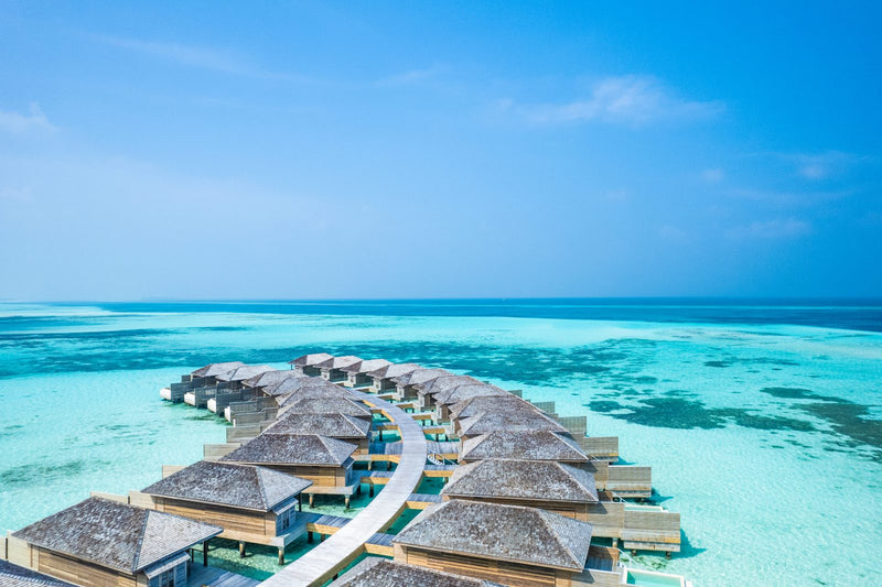 Jawakara Islands Maldives, Lhaviyani Atoll: Dheru water pool villas along a curving jetty over the lagoon