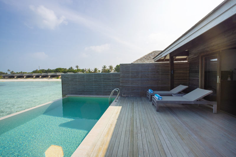 Jawakara Islands Maldives, Lhaviyani Atoll: a water pool villa deck with a private pool and sun loungers over the lagoon