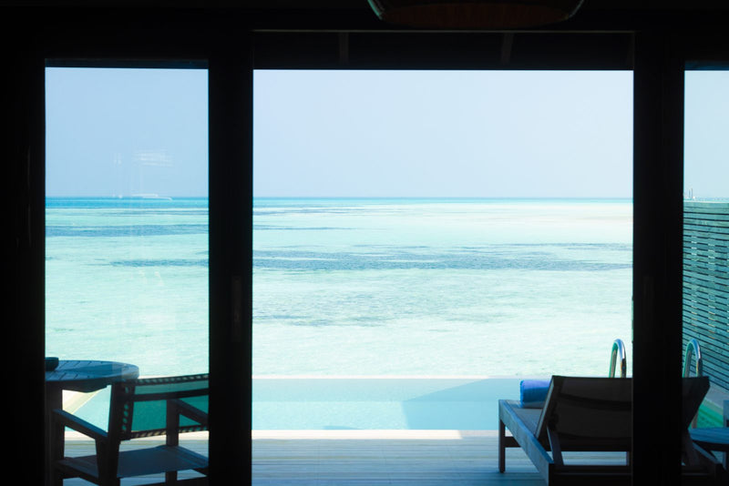 Jawakara Islands Maldives, Lhaviyani Atoll: the view from inside a water pool villa across the deck to the shallow lagoon