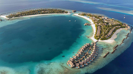 ananea Madivaru Maldives from the air, the island curving round a wide shallow lagoon