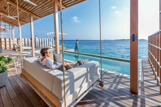 Kudadoo Maldives Private Island, Lhaviyani Atoll — a guest resting on the deck&