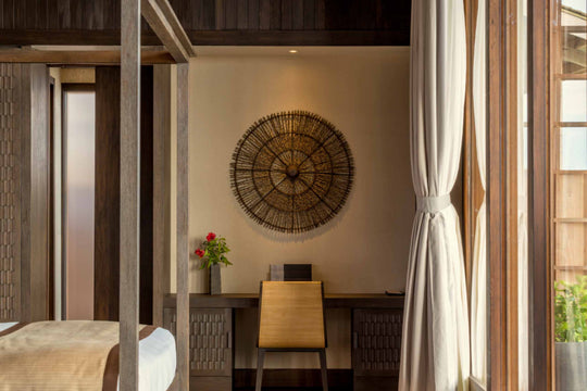 Kudadoo Maldives Private Island, Lhaviyani Atoll — writing desk and woven sunburst wall panel in the corner of a residence bedroom