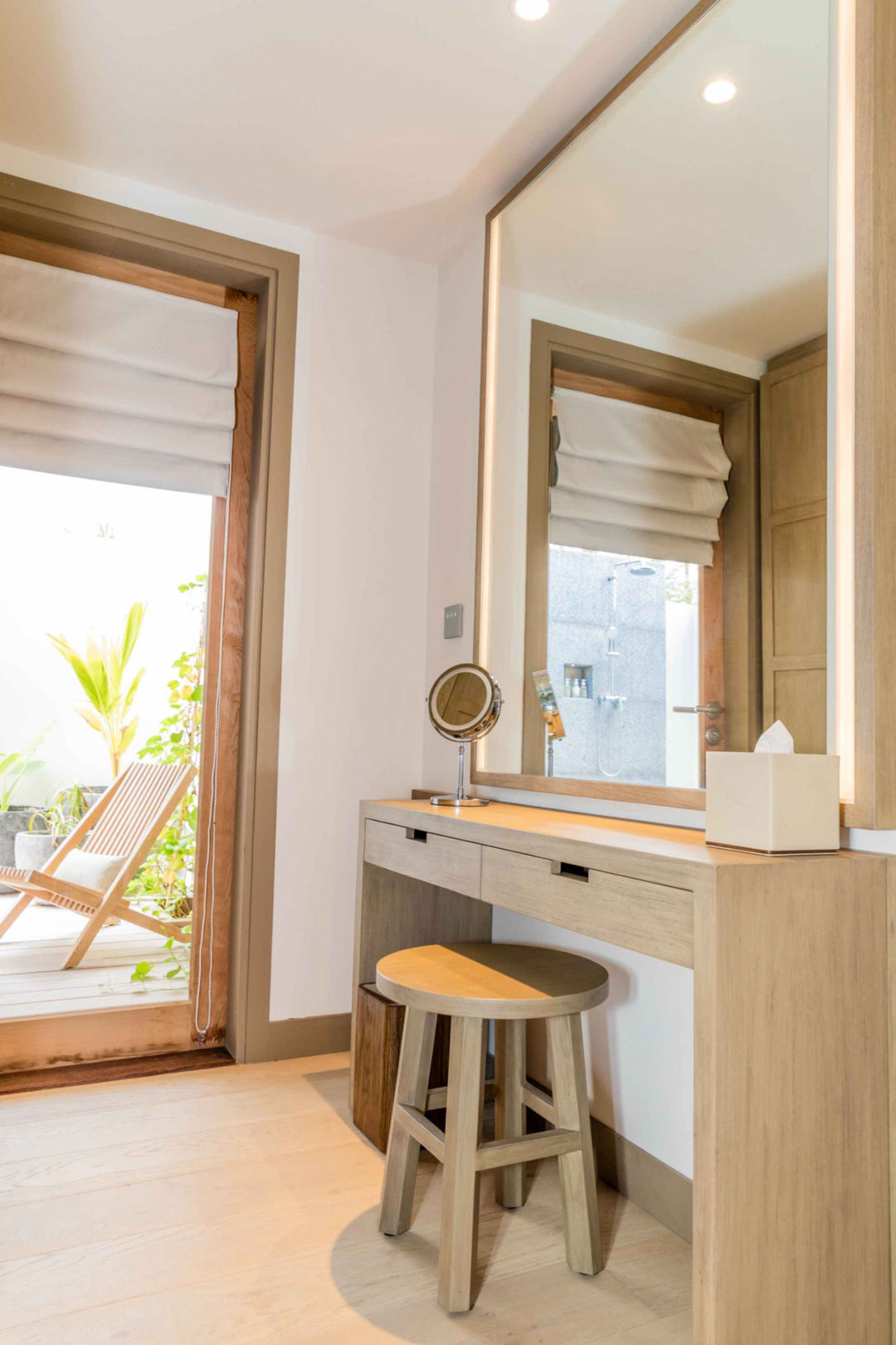 Kagi Maldives Resort &amp; Spa, North Malé Atoll — villa dressing area with a large mirror, vanity drawers and a view through to the outdoor shower