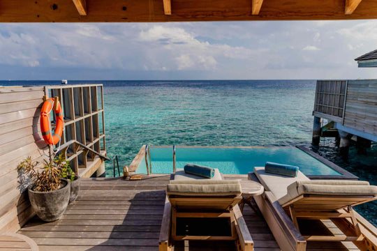 Kagi Maldives Resort &amp; Spa, North Malé Atoll — overwater villa deck with sun loungers and a private pool set at the edge above clear turquoise water