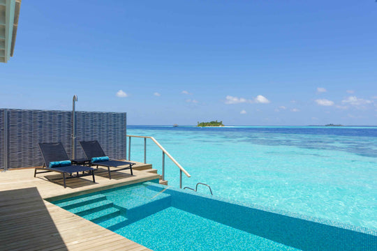 Private plunge pool on an over-water deck, sitting level with the turquoise lagoon