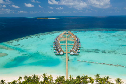 Aerial view of the villa jetty reaching from the beach out to the deep water at the reef edge