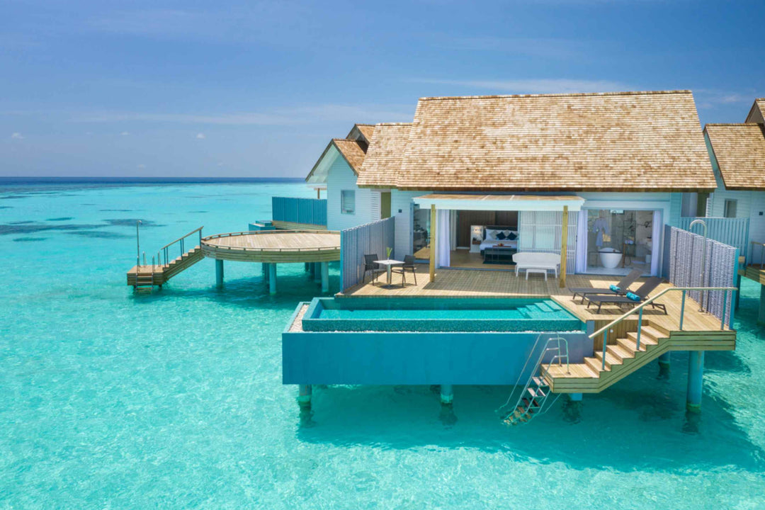 Over-water villa with a private pool on its deck and steps leading down into the lagoon