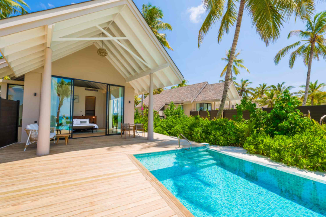 A Beach Pool Villa at ananea Madivaru Maldives seen along its pool, the bedroom open to the terrace