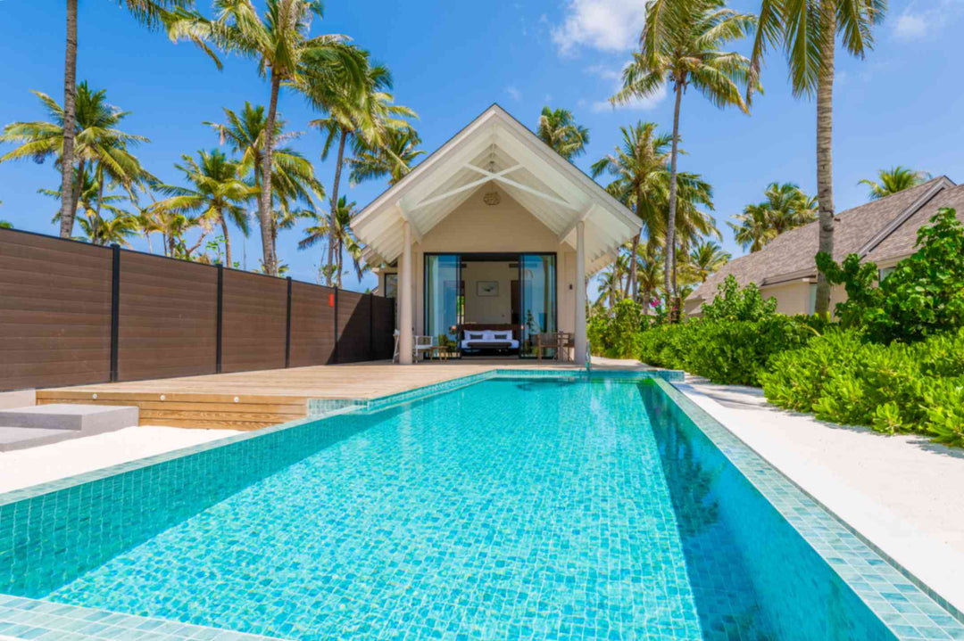 Beach Pool Villa at ananea Madivaru Maldives, pitched roof villa behind a long private pool set among palms