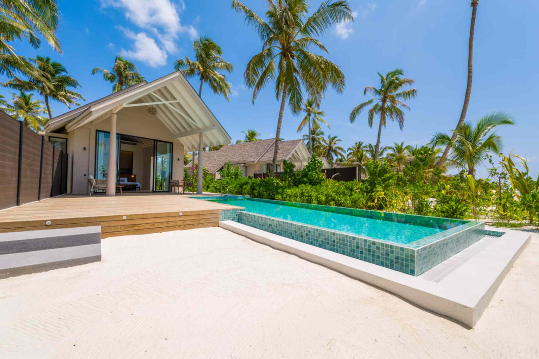 The pool of a Beach Pool Villa at ananea Madivaru Maldives running out from the terrace into the garden
