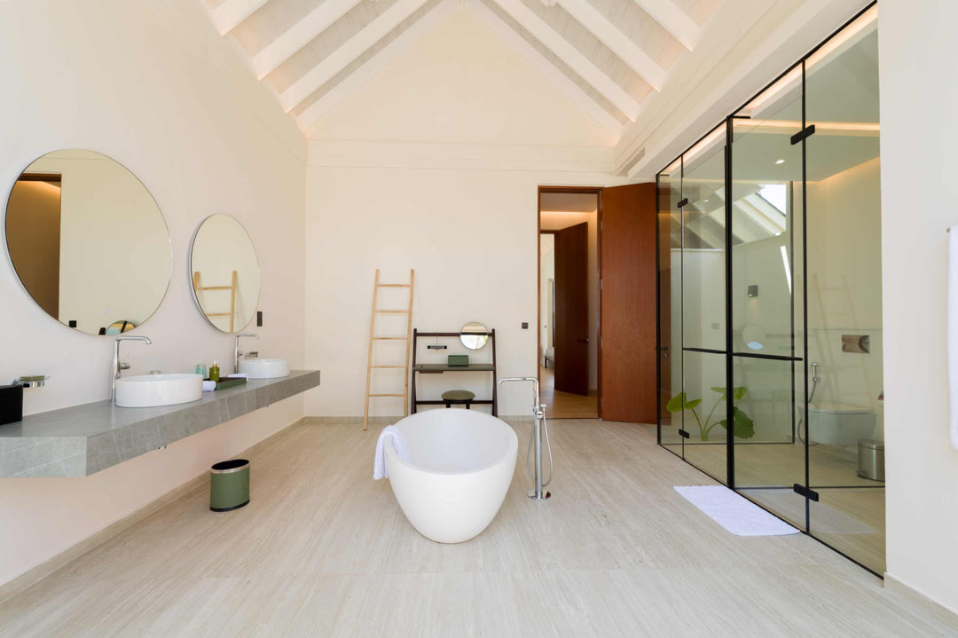A villa bathroom at ananea Madivaru Maldives, long vanity with two basins and a freestanding bath