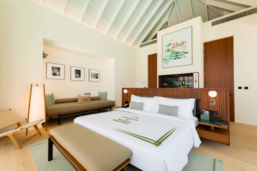 A Deluxe Beach Pool Villa bedroom at ananea Madivaru Maldives with a daybed under framed prints