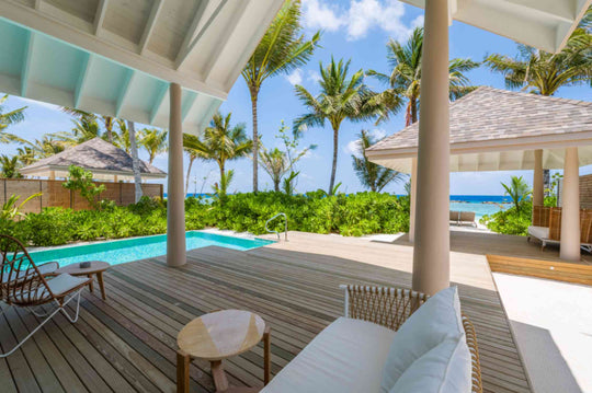The deck of a beach villa at ananea Madivaru Maldives between the pool and the palms, the sea beyond