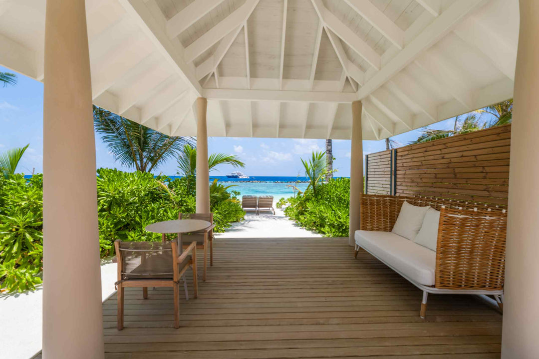 A daybed on the shaded terrace of a beach villa at ananea Madivaru Maldives, looking out to the sea