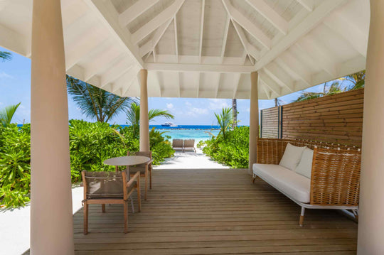 A daybed on the shaded terrace of a beach villa at ananea Madivaru Maldives, looking out to the sea