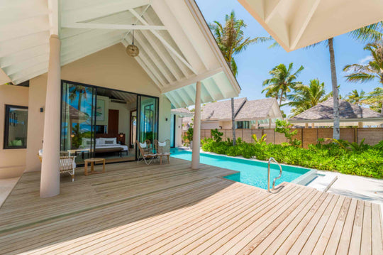 A Deluxe Beach Pool Villa at ananea Madivaru Maldives, the long pool running past the bedroom doors