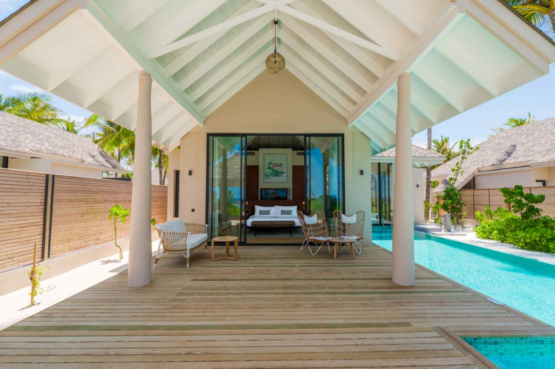 A beach villa at ananea Madivaru Maldives seen from the garden, the bedroom framed between the terrace columns