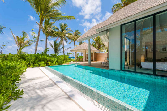 The pool of a Deluxe Beach Pool Villa at ananea Madivaru Maldives running towards the beach and the palms