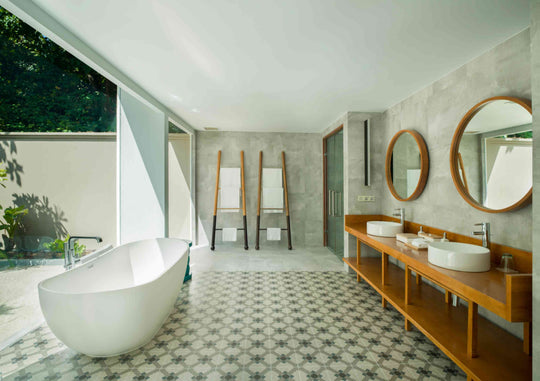 A Beach Pool Villa bathroom at Amilla Maldives, freestanding tub and twin basins open to the garden