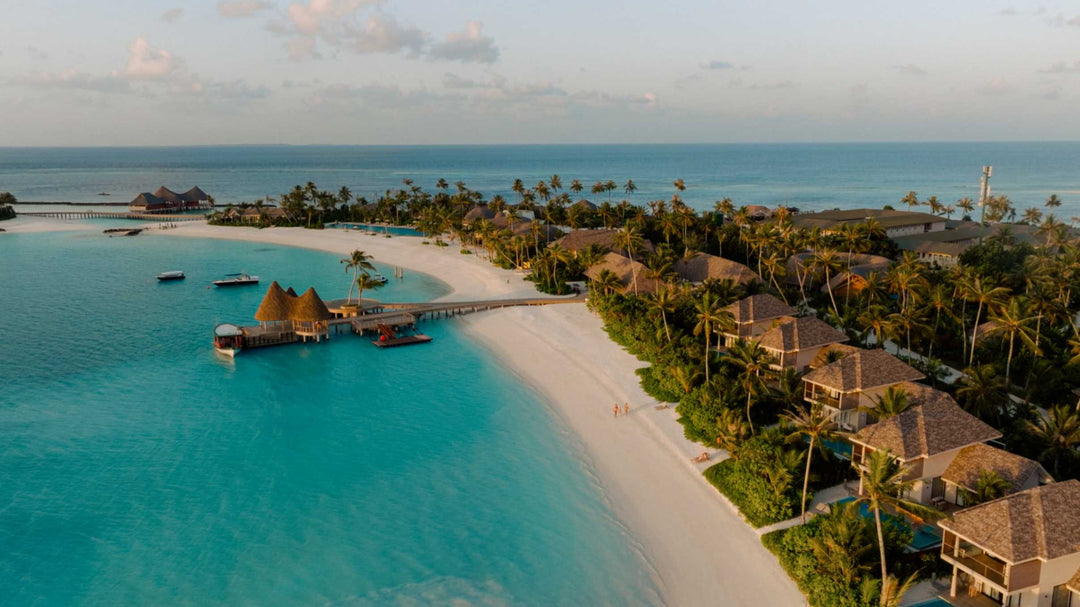 ananea Madivaru Maldives from the air, the jetty and thatched roofs between the beach and the lagoon