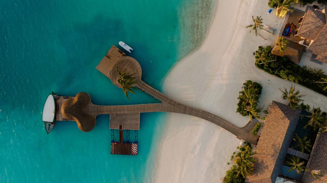 The arrival jetty at ananea Madivaru Maldives from directly above, a seaplane moored alongside