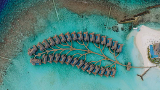 The overwater villas at ananea Madivaru Maldives from the air, arranged along a jetty over the lagoon