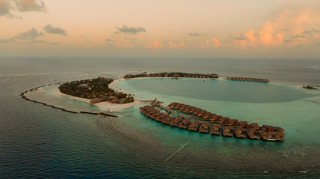 ananea Madivaru Maldives from the air, the overwater villas reaching into a wide turquoise lagoon
