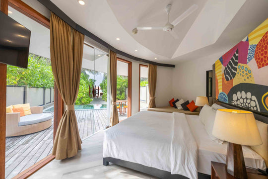 Angsana Velavaru, Dhaalu Atoll — family villa bedroom with the doors open onto the pool deck
