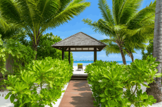 Angsana Velavaru, Dhaalu Atoll — a Thai sala at the end of a boardwalk through the garden to the beach