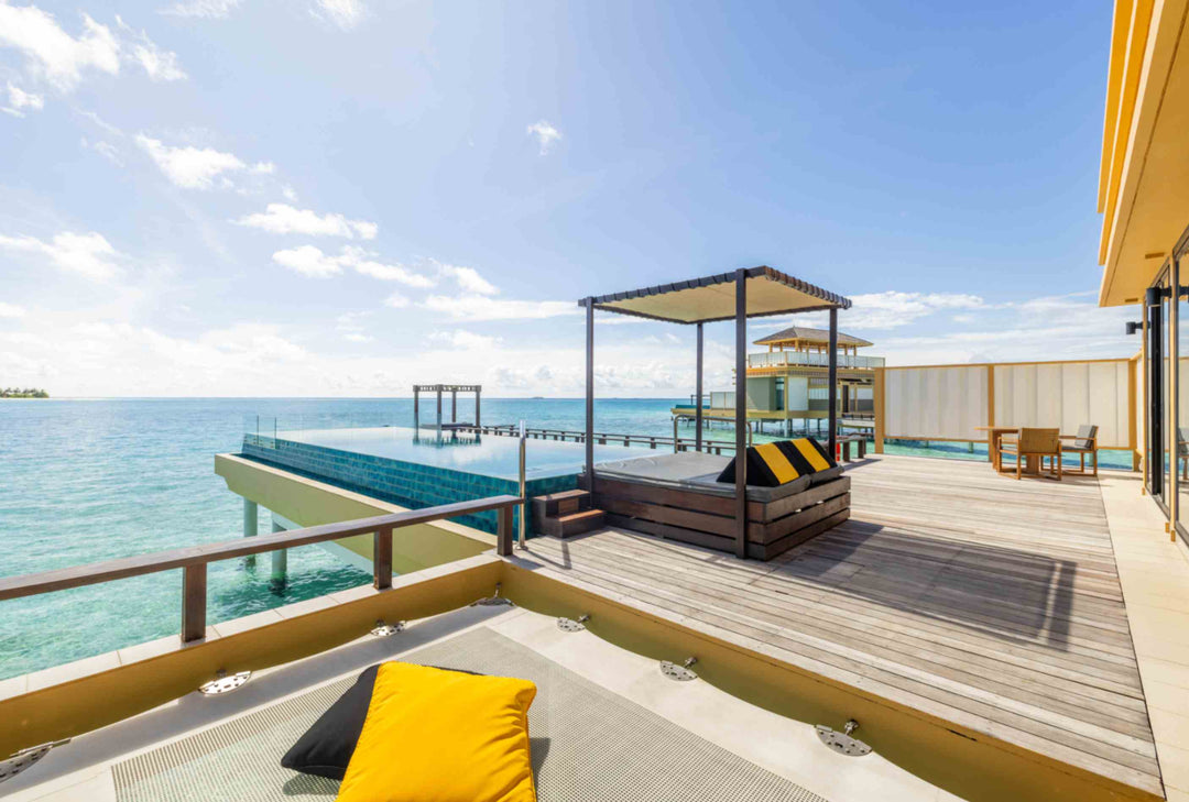 Angsana Velavaru, Dhaalu Atoll — a canopied daybed on the deck of a Deluxe InOcean Pool Villa, beside the pool