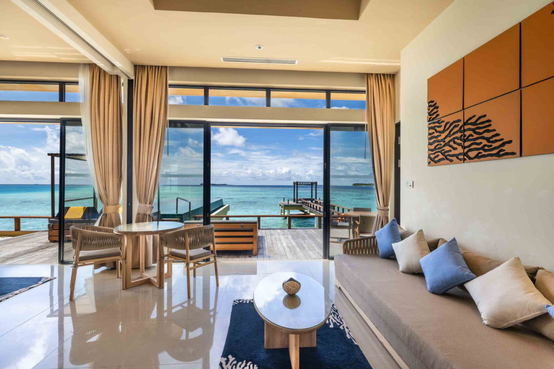 Angsana Velavaru, Dhaalu Atoll — sitting area of the two-bedroom overwater villa, with the sea on two sides