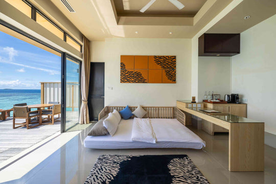 Angsana Velavaru, Dhaalu Atoll — sofa bed made up in the two-bedroom overwater villa, beside the coffee counter