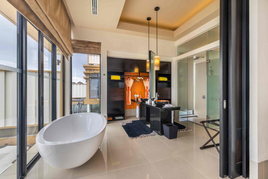 Angsana Velavaru, Dhaalu Atoll — Deluxe InOcean villa bathroom with a freestanding bath, wardrobe and walk-in shower