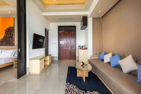 Angsana Velavaru, Dhaalu Atoll — the living area of a Deluxe InOcean villa, looking through to the bedroom