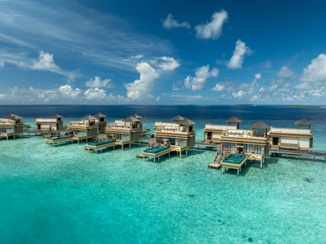 Angsana Velavaru, Dhaalu Atoll — aerial view of the InOcean villas standing on the reef, away from the island
