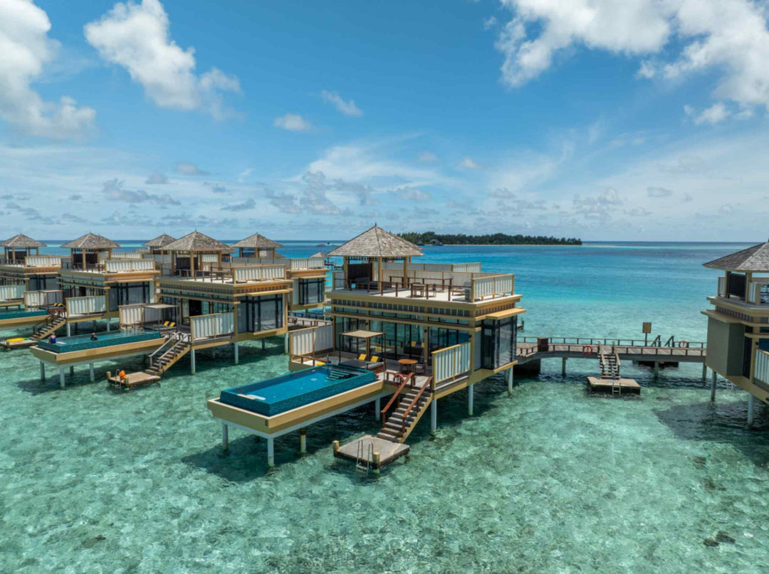 Angsana Velavaru, Dhaalu Atoll — the InOcean cluster from the air, two-storey villas each with a pool on the deck