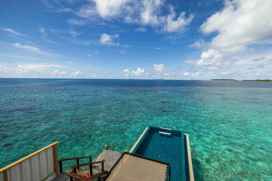 Angsana Velavaru, Dhaalu Atoll — an InOcean villa infinity pool at the edge of the deck, looking out over the lagoon